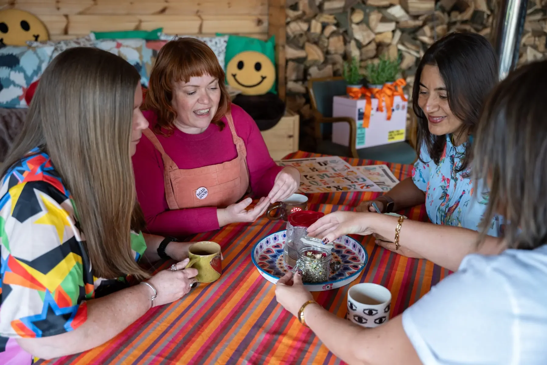 Women working and talking together around a colourful table
